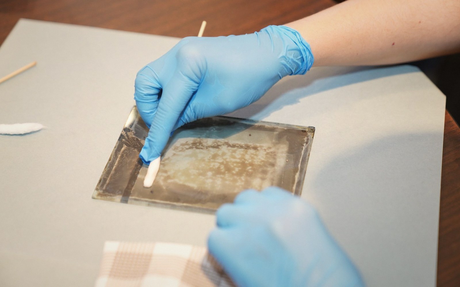 A half-cleaned painting surface with the test window visible